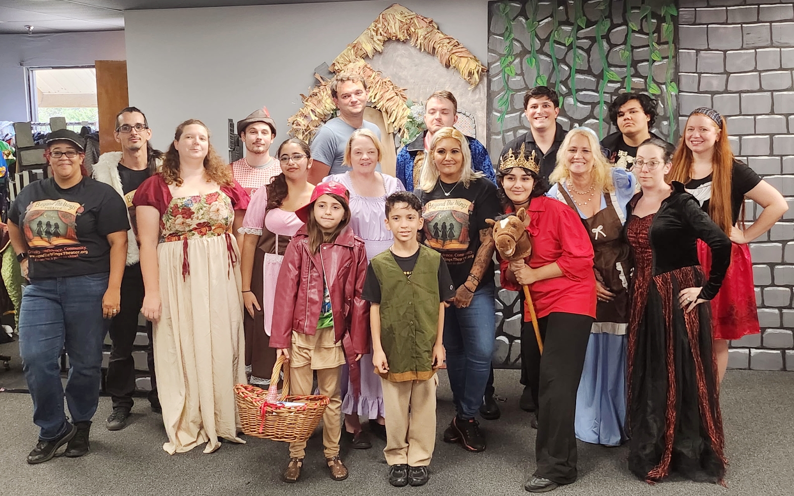 The full cast of The Brothers Grimm Spectaculathon poses in costume on the fairy-tale set.